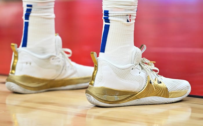 Philadelphia 76ers center Joel Embiid's white and gold Under Armour shoes.